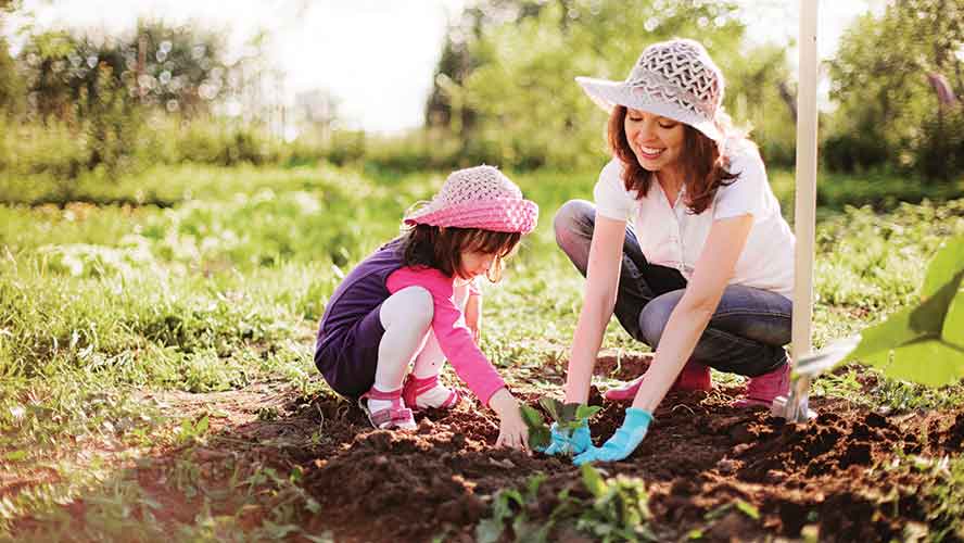 mother and young daughter gardening